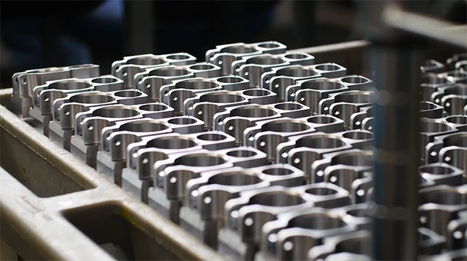 Metal parts lined up on table
