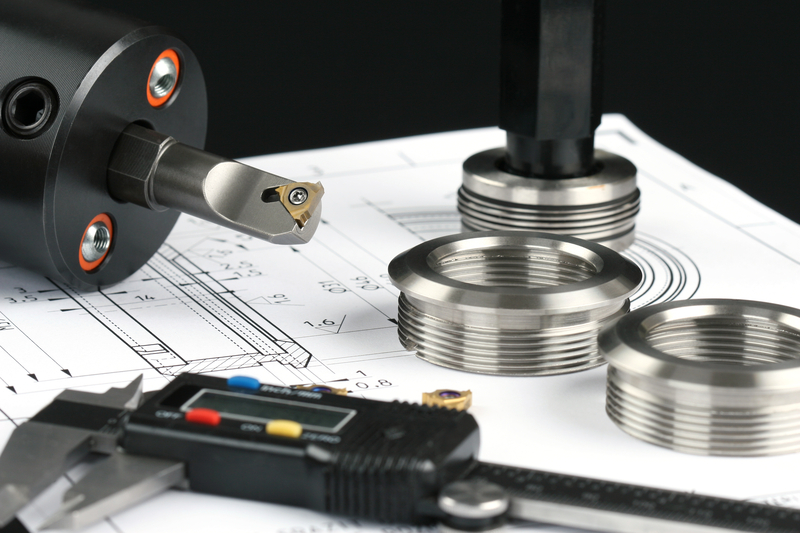 CNC turning parts with CAD drawing on table